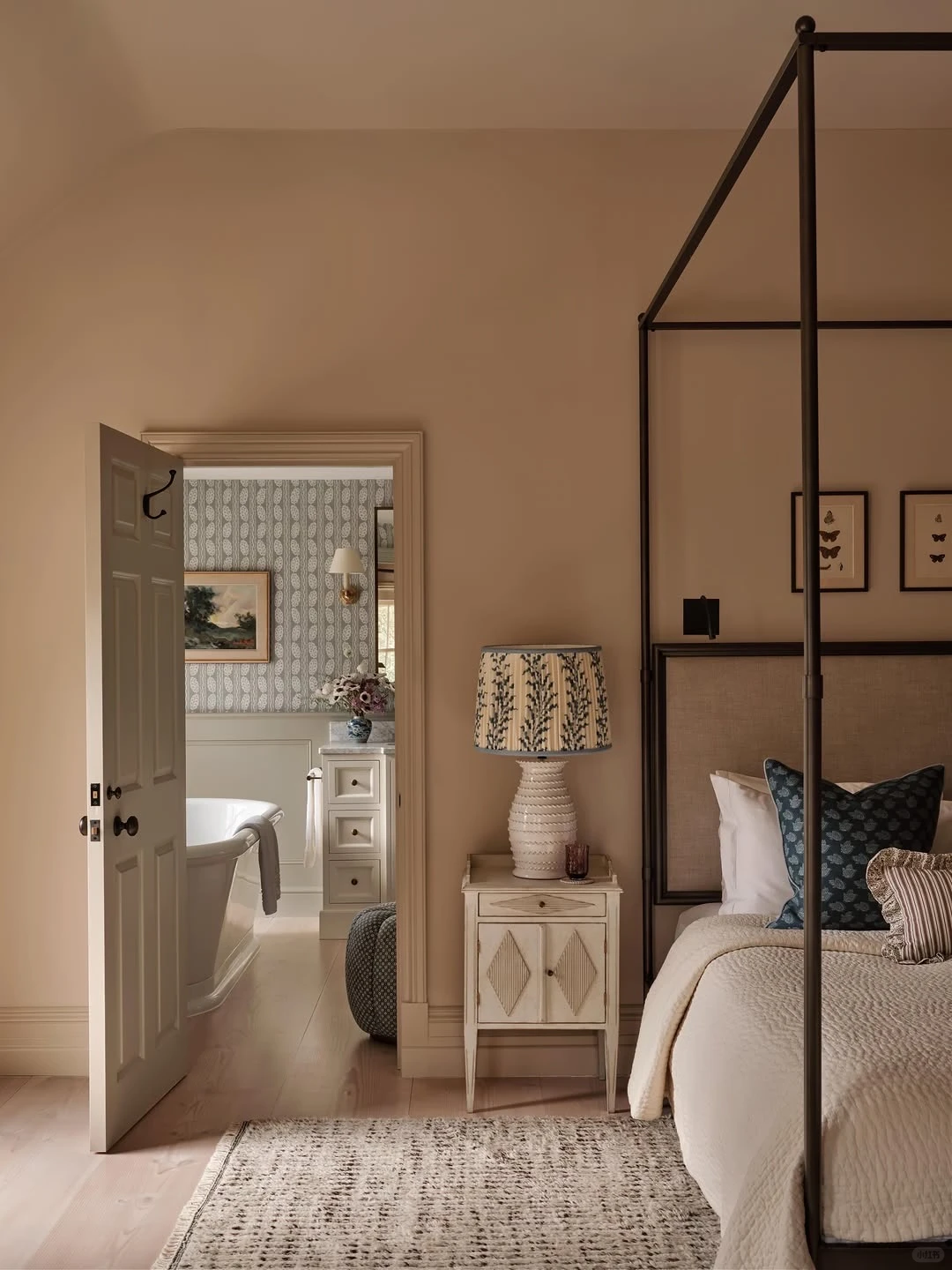 Real interior photograph of a dark-frame canopy bed